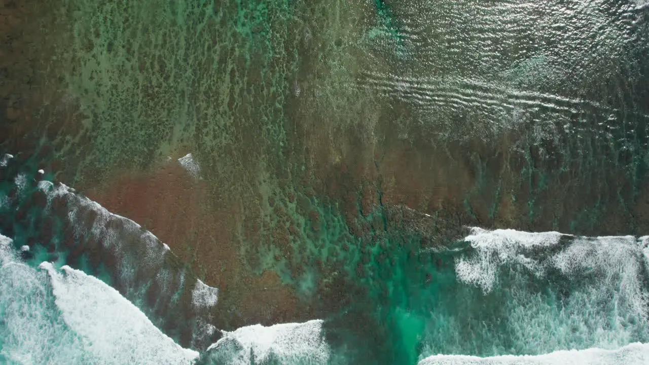 Aerial view of waves crashing over reef in Kauai Hawaii