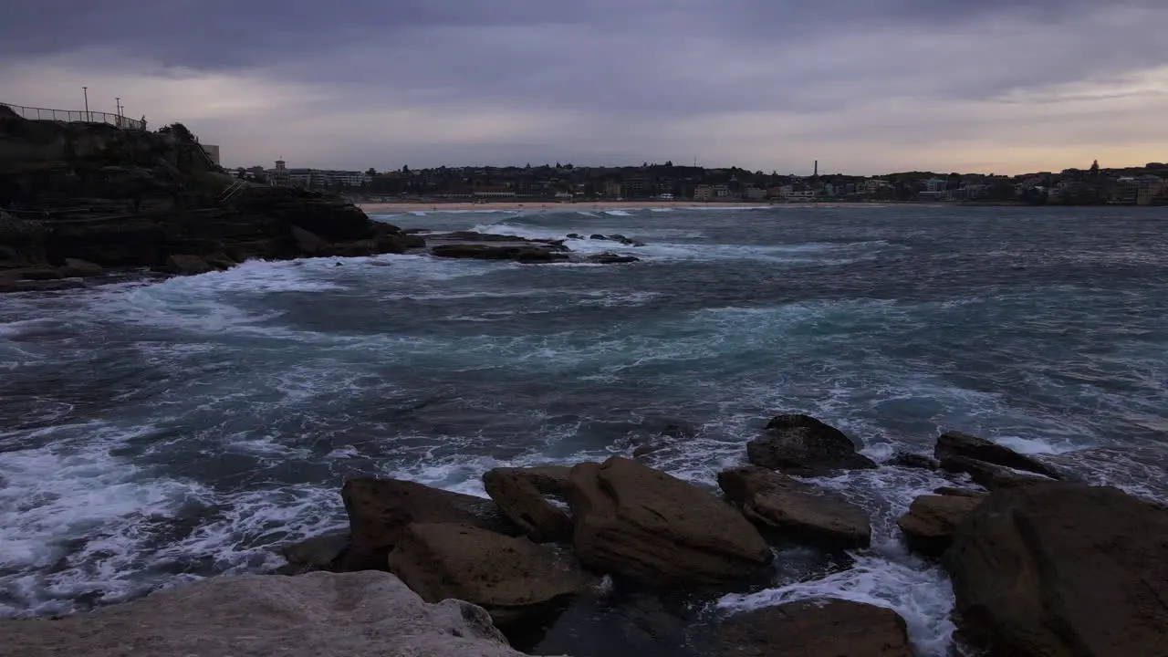 Waves crashing on rocks stormy sky white foam