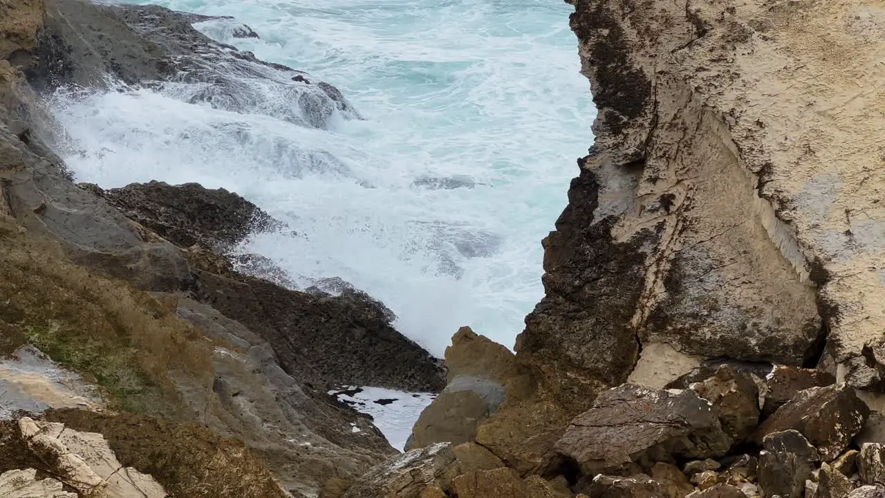 Cinematic slow motion footage of waves crashing against rocks in Peniche Portugal Europe Slomo