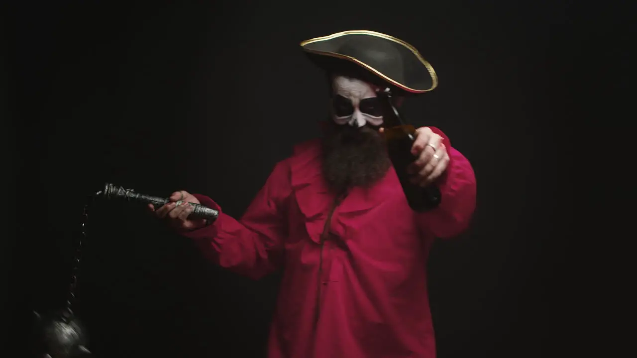 Man dressed up like a drunk pirate over black background