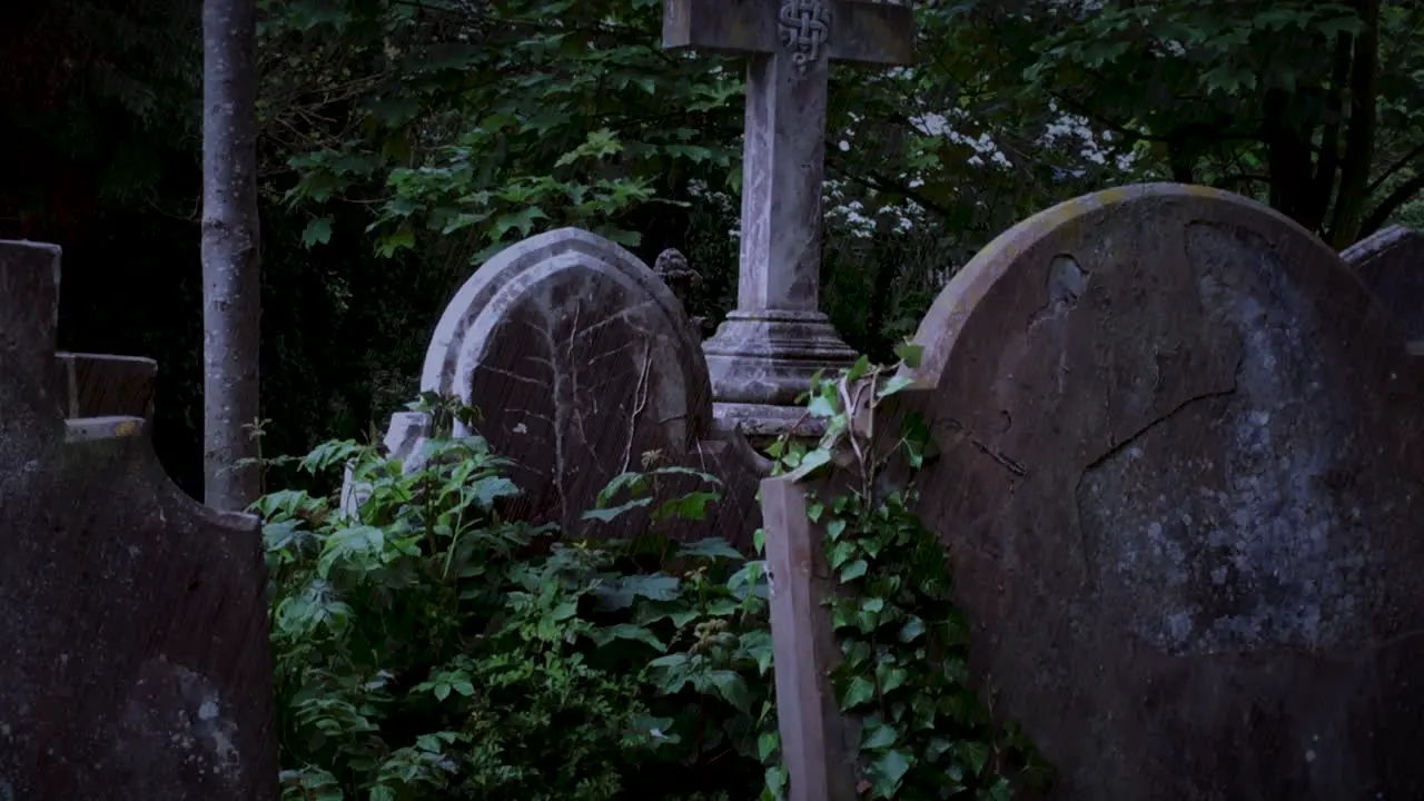 Tombstones in graveyard at night in a thunderstorm