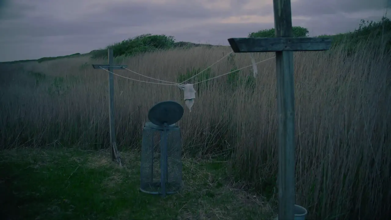 Cinematic Ominous Abandoned Washing Line and Bin in Stormy Conditions