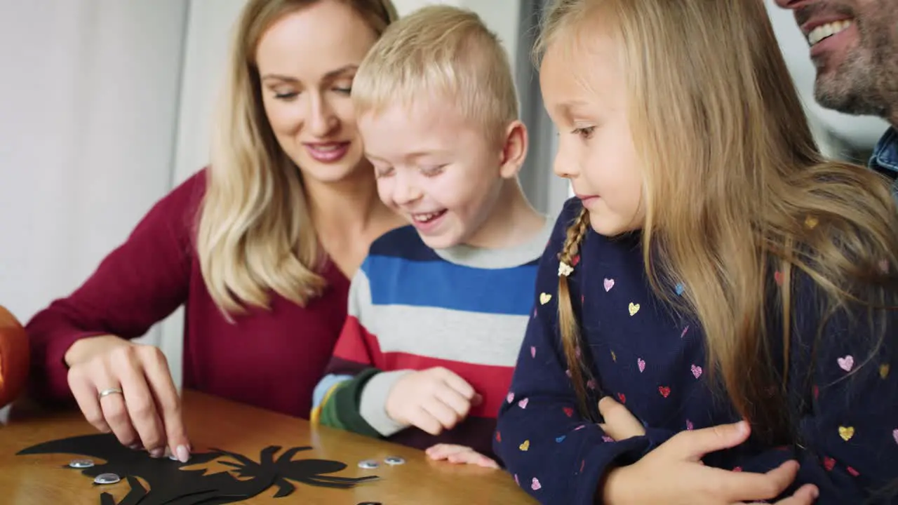 Handheld video of happy family preparing decoration for Halloween