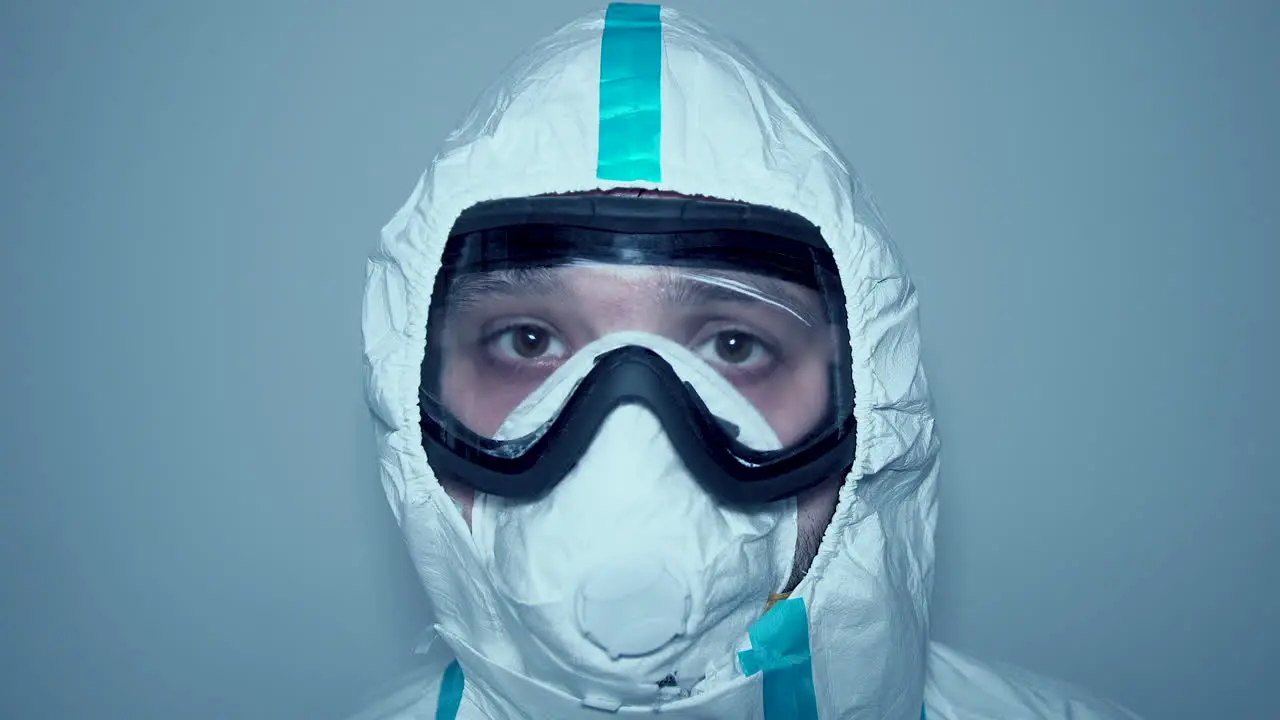 Static shot of hospital worker face with mask and goggles covid-19 protective gear