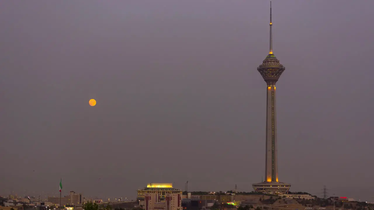 Moon Rese Over Air Pollution on Milad Tower in Big City of Tehran in Iran Middle East in Asia in Gray Color Sky After Sunset twilight