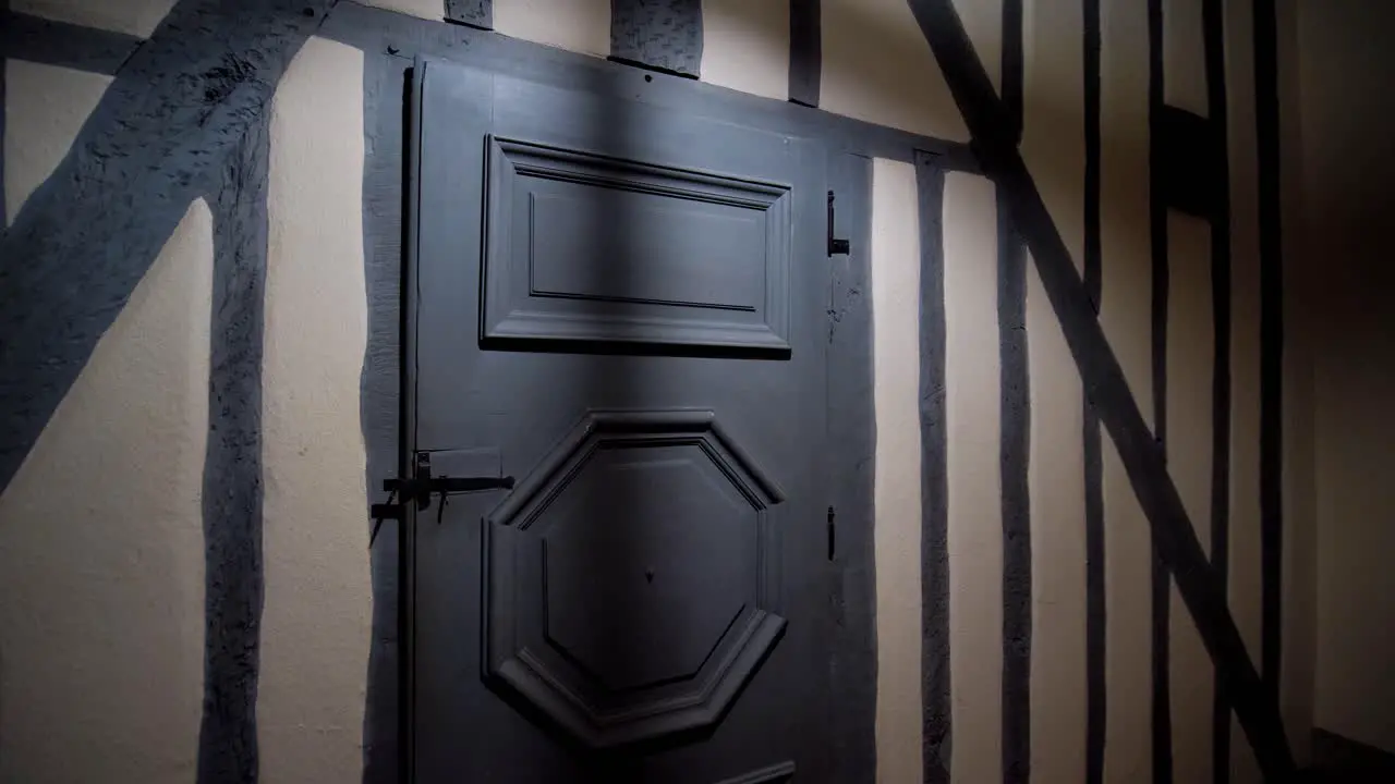 Dimly Lit Gray Door in an Attic with Low Ceiling Light