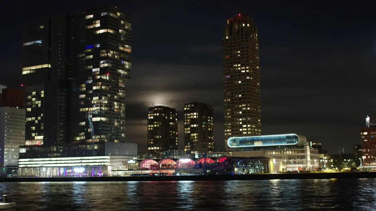 Time lapse of the skyline of Rotterdam during night time with a full moon