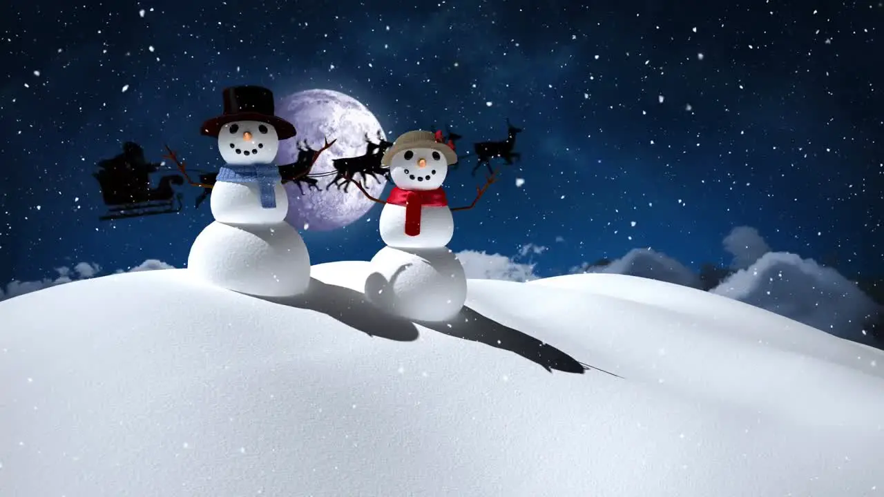 Snow falling over snowman and snowwoman on winter landscape against moon in the night sky