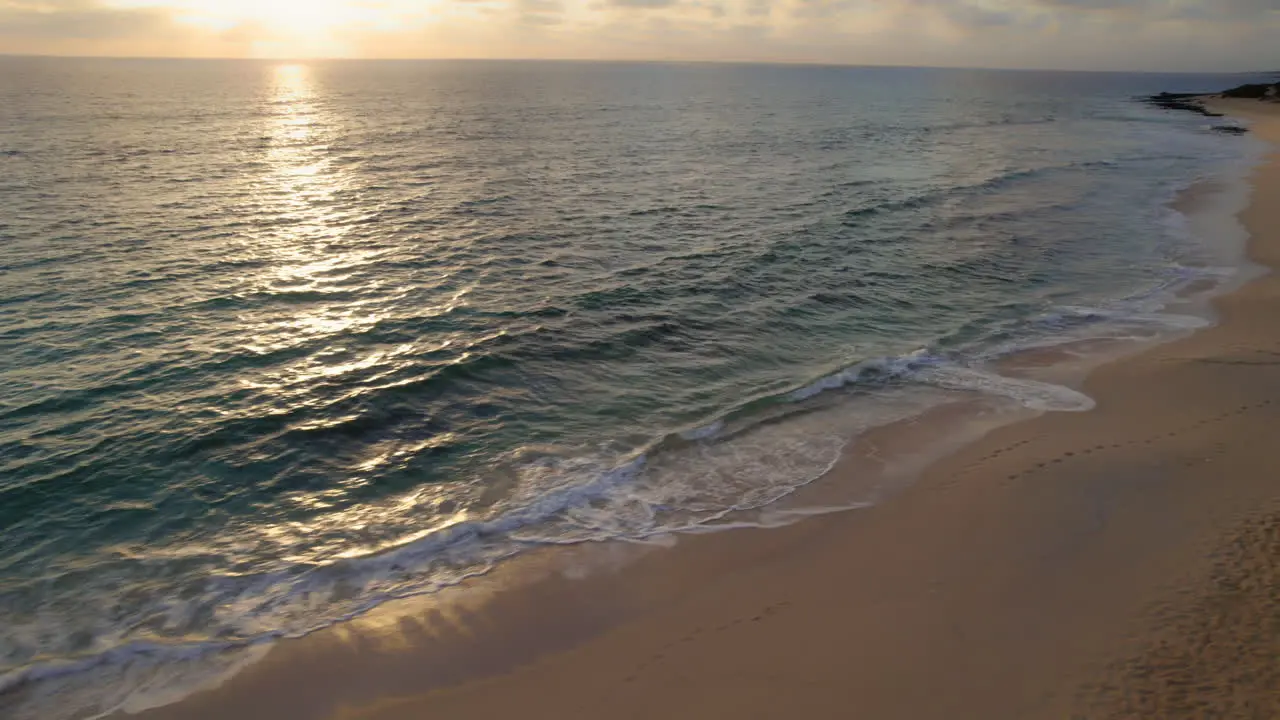 Ocean waves gently splashing on sandy beach