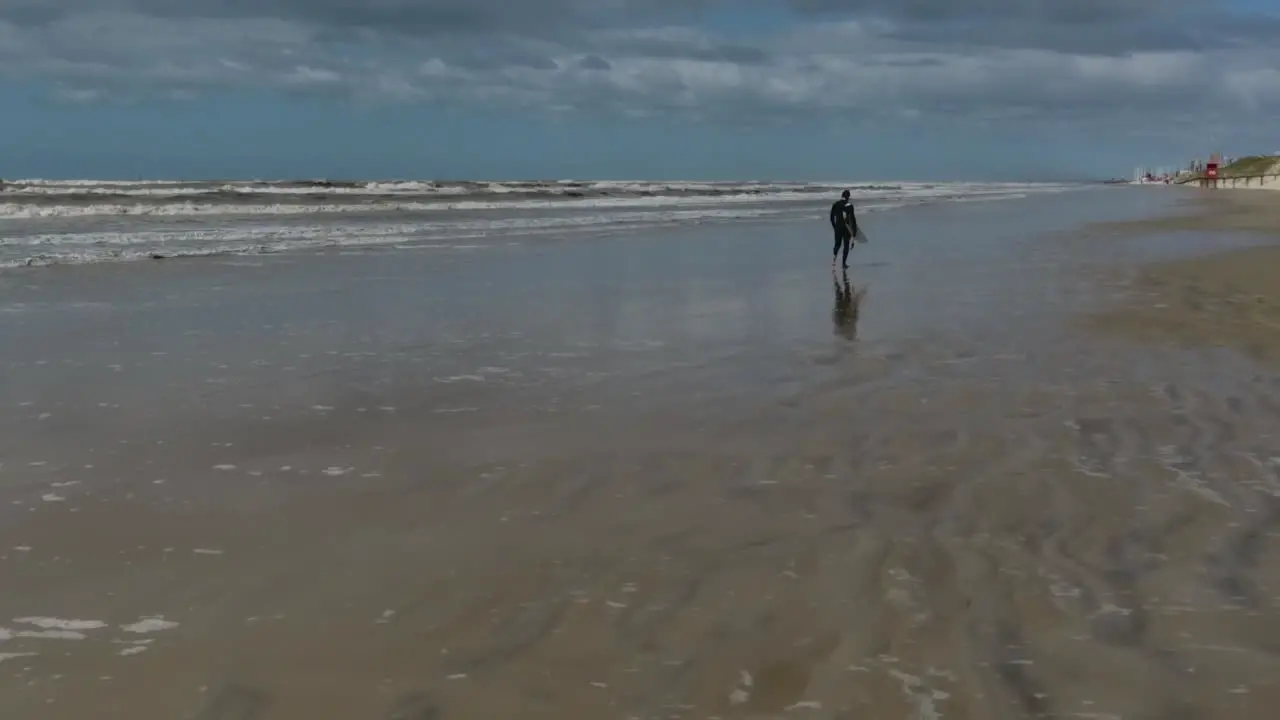 Surf guy on the beach in slow motion