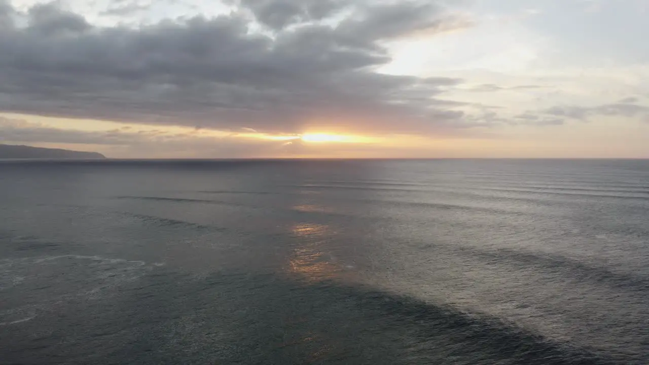 4K cinematic drone shot of the sunset over the ocean at Banzai Pipeline on Oahu's North Shore