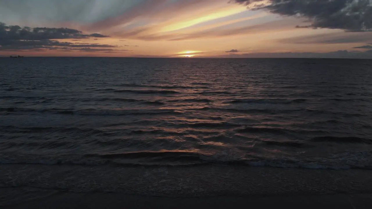 Aerial view of splashing sea waves at dusk after sunset