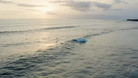 Drone Shot Pulling Away from Group of Surfers Out at Sea