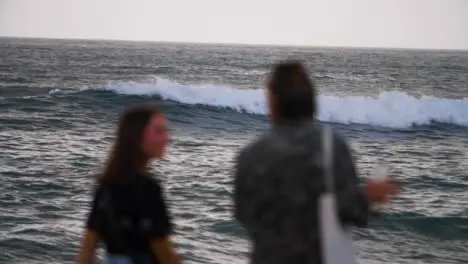 Defocused Handheld Shot of People Walking Along Pererenan Beach Shore