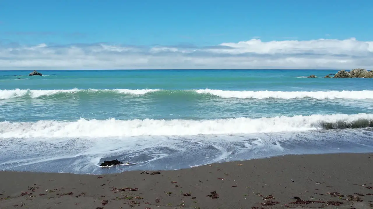 Drone flying parallel to beach in slow-motion