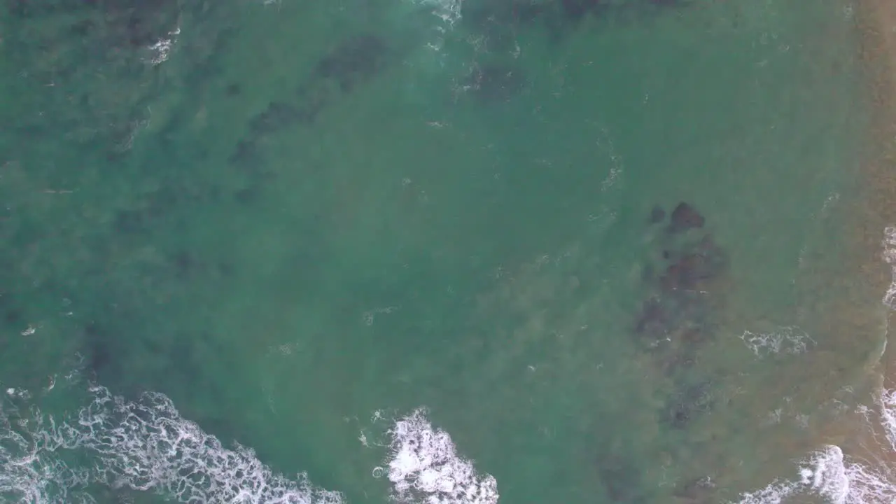 Vertical slow moving drone footage of waves along te coast at Point Lonsdale Victoria Australia