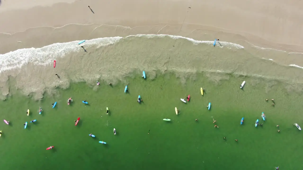 Surfers and colorful surfboards in Hong Kong beach Aerial view