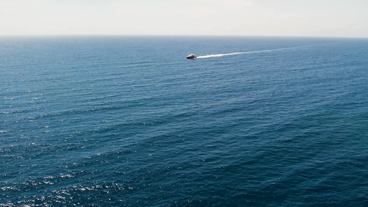 Aerial drone tracking video of cruise ship in deep blue open Caribbean sea Honduras