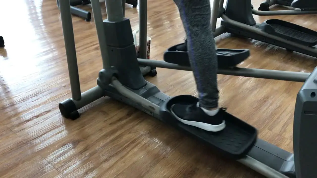 Close up foot working out on the stepper exercise machine at the gym stepper machine on the wooden floor