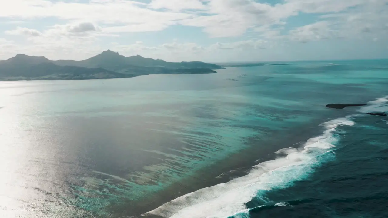 Waves crashing in over reef outside tropical island Mauritius