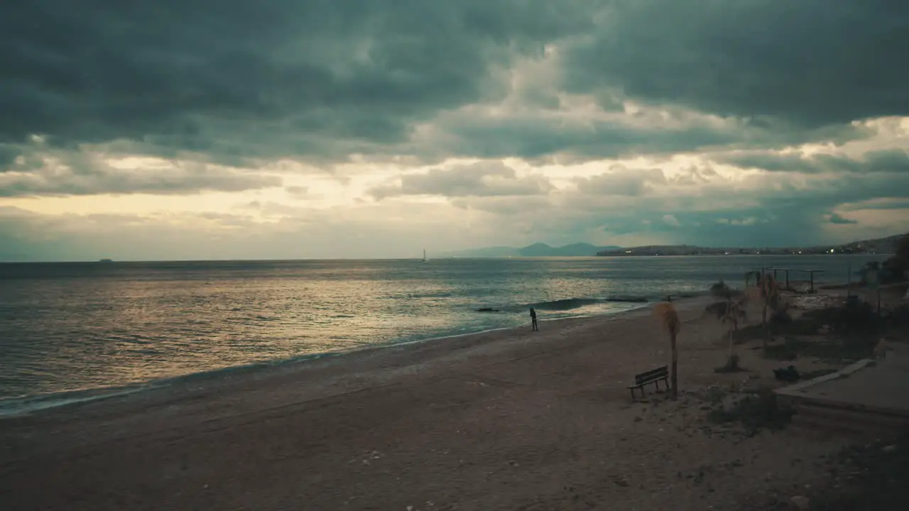 Cinematic view of city beach and cloudy sky at sunset