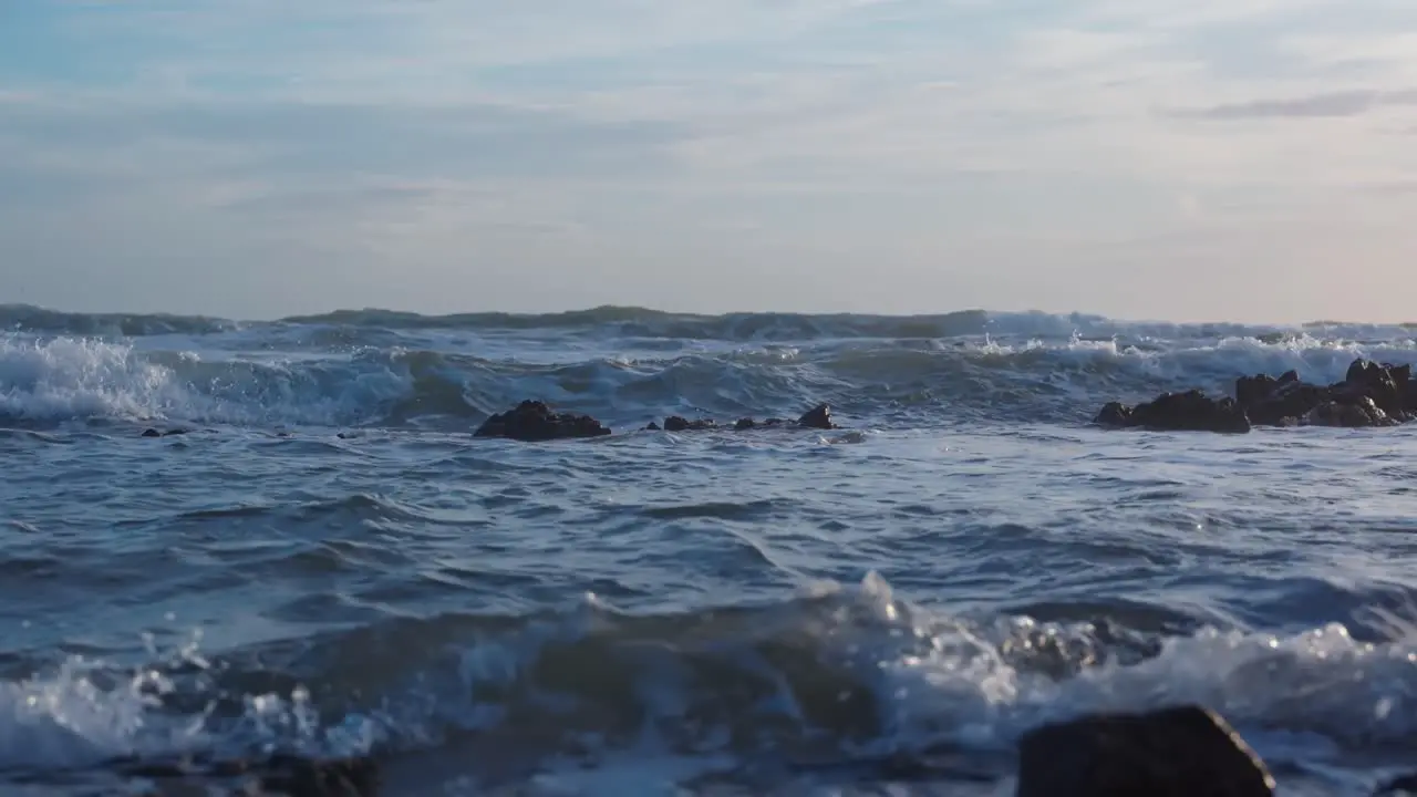 Blue ocean waves on a cloudy day