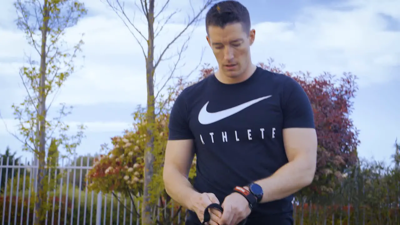 Slowmotion shot of an athletic man putting on gymnastic hand grips