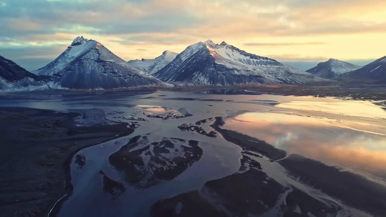 Snowy mountains against sundown sky