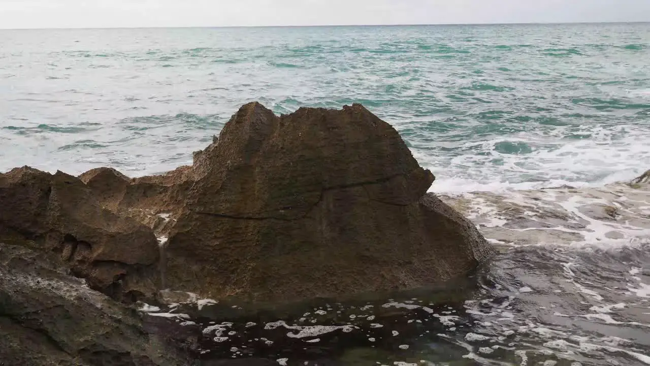 Waves crashing over Oahu's volcanic rocks