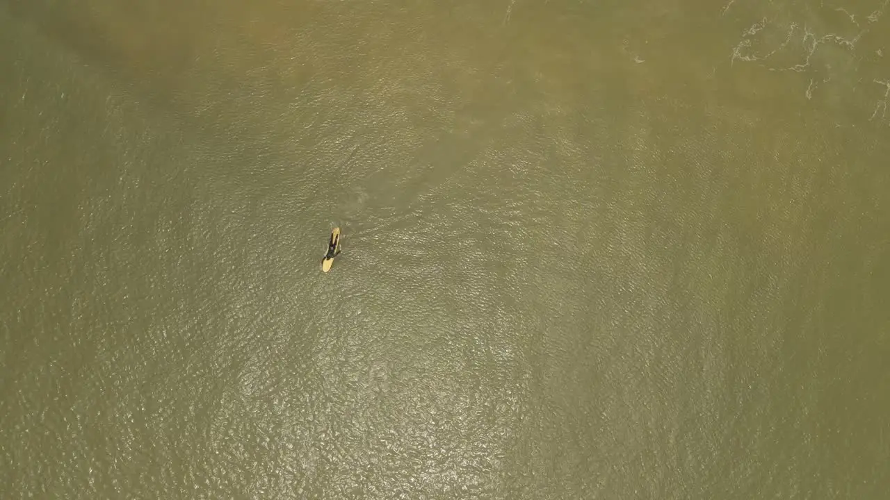 Rookie surfer learning to paddle at La Pedrera Atlantic ocean Uruguay