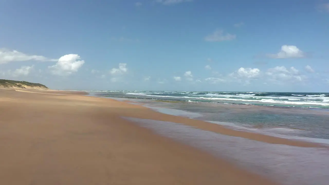 Forward Flying Ascending Shot of Vast Chidenguele Beach in Mozambique