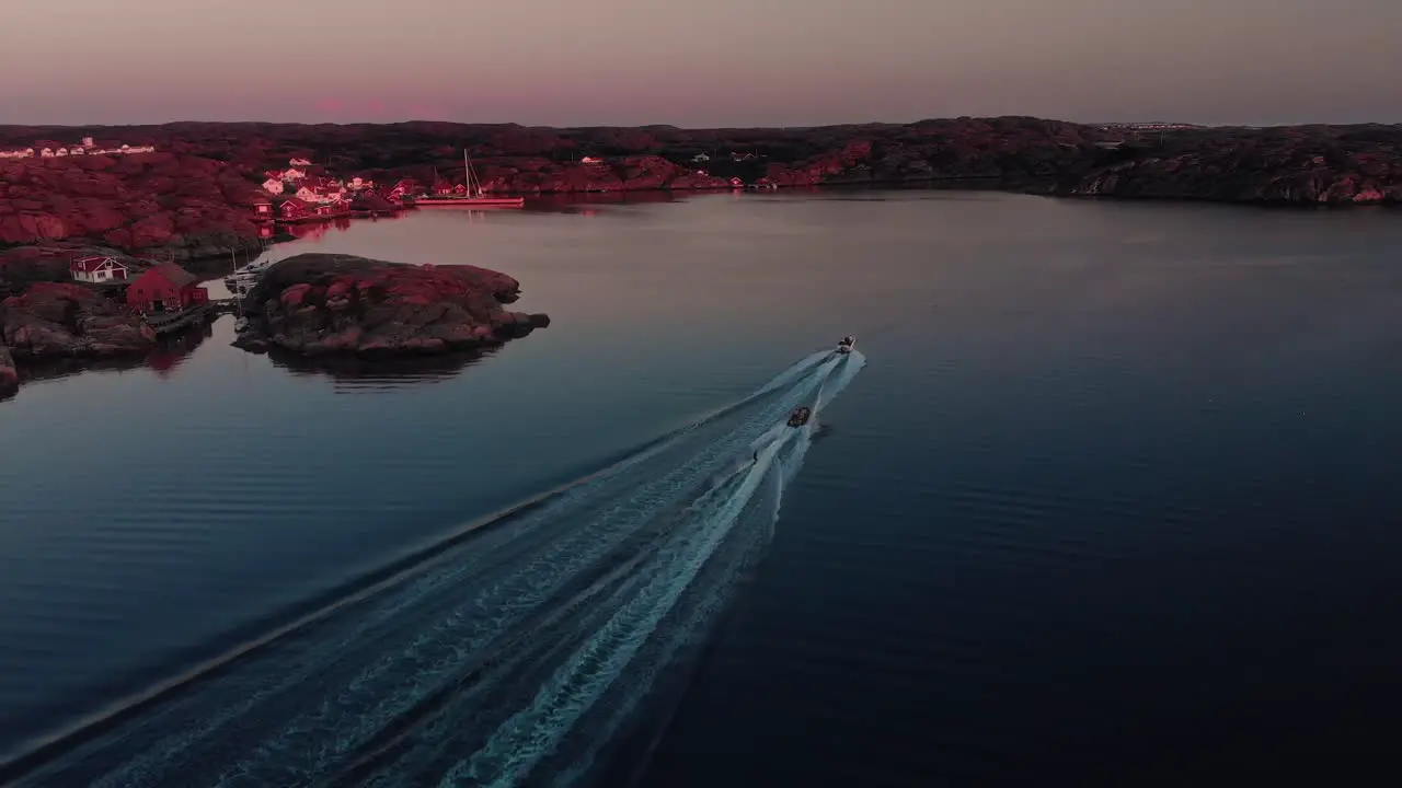 drone flies over Swedish archipelago at sunset in skarhamn with water skis