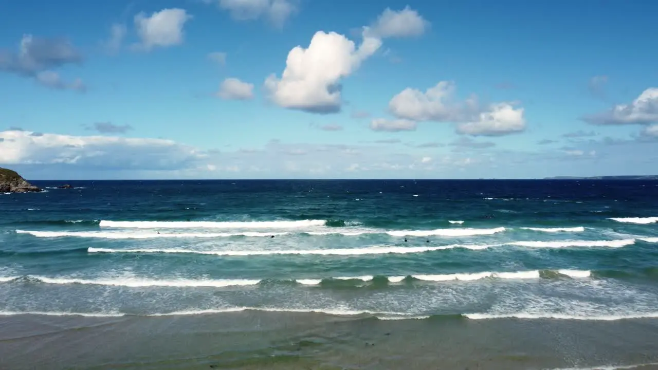 Aerial shot above the sea capturing waves at Newquay beach Cornwall England Uk