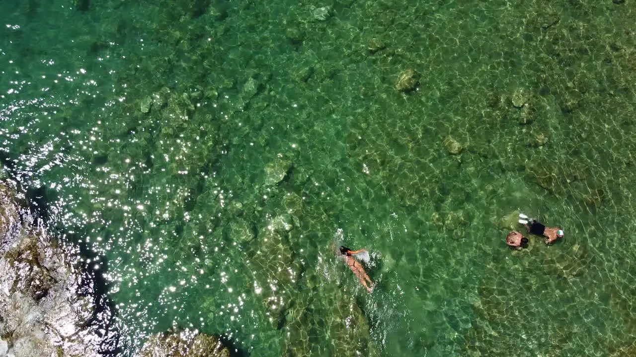 People having a bath on the crystal clear waters at Cardellino beach Castiglioncello