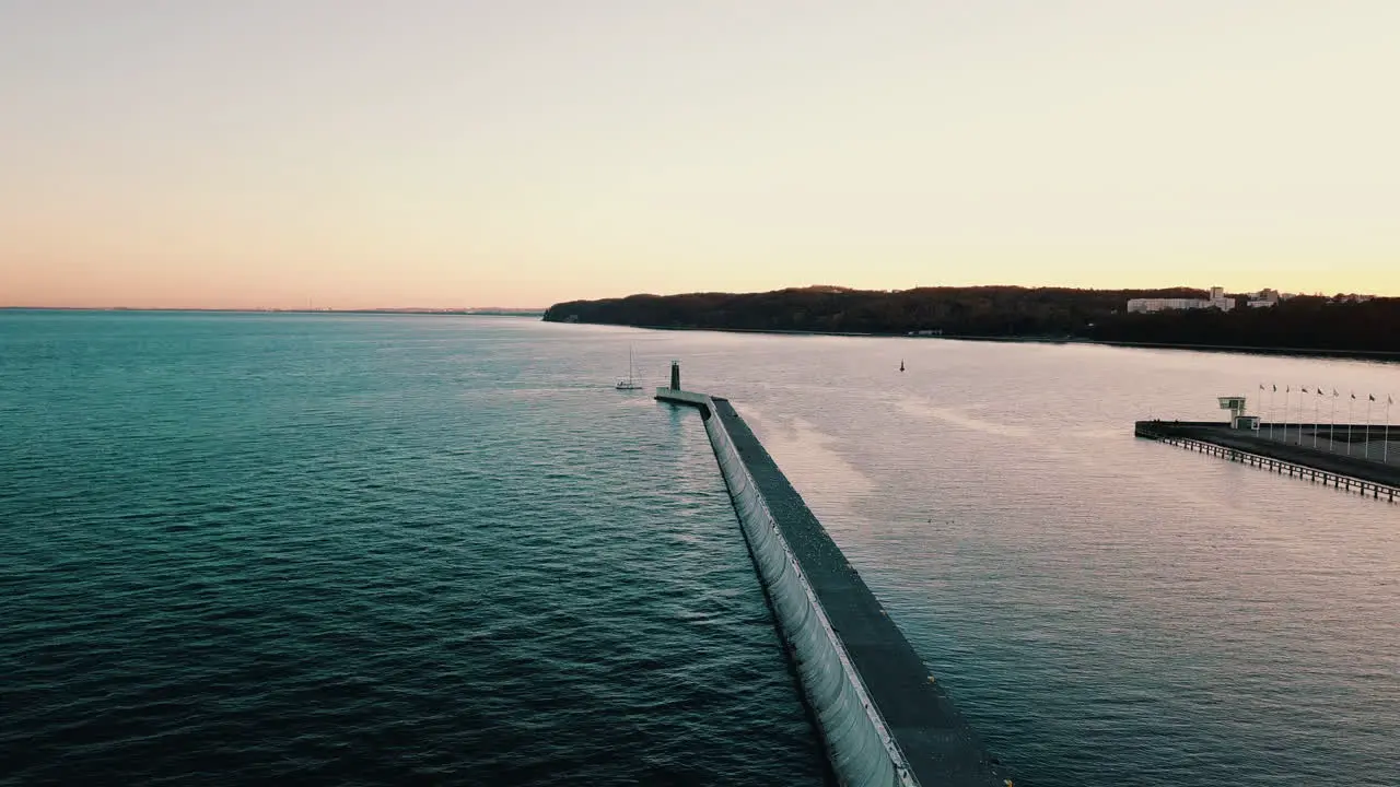 Drone flying above the yacht sailing into the bay at the sunset-1