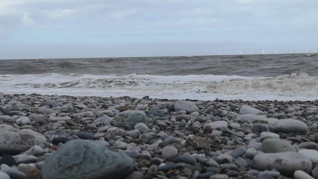 February 2022 storm Eunice splashing waves on English pebble stone beach