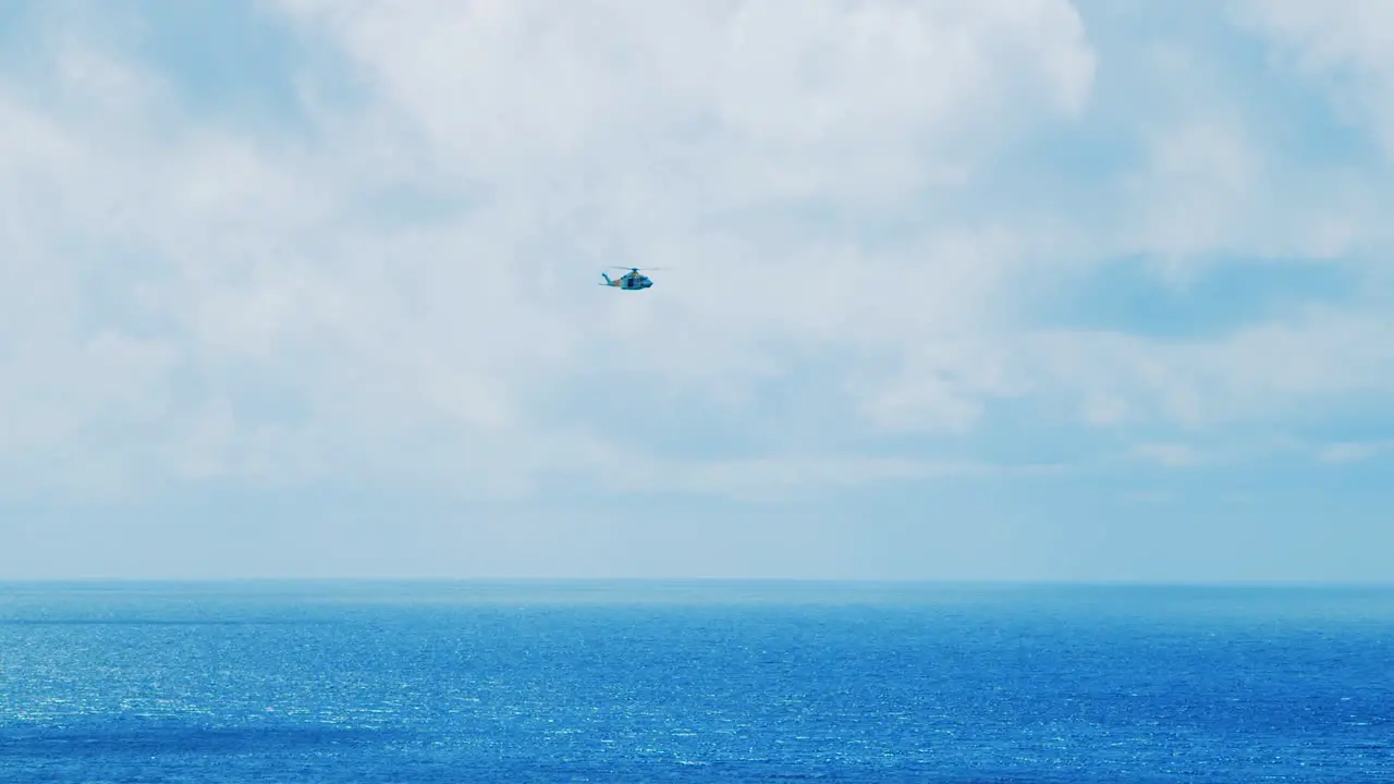 Curacao Coastguard helicopter flying across the ocean on a clear and sunny day in Curacao