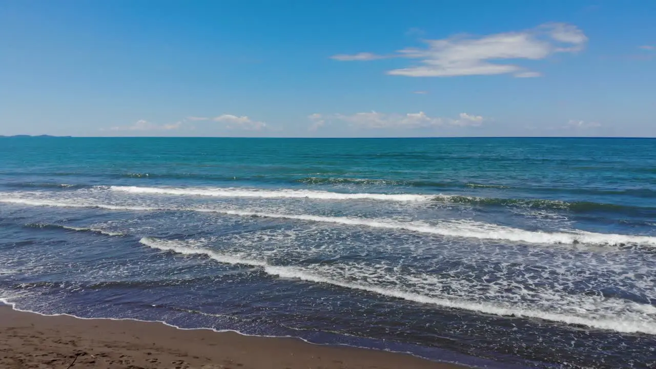 White waves of turquoise sea splashing on sandy beach on a wild seaside in Adriatic seaside Albania