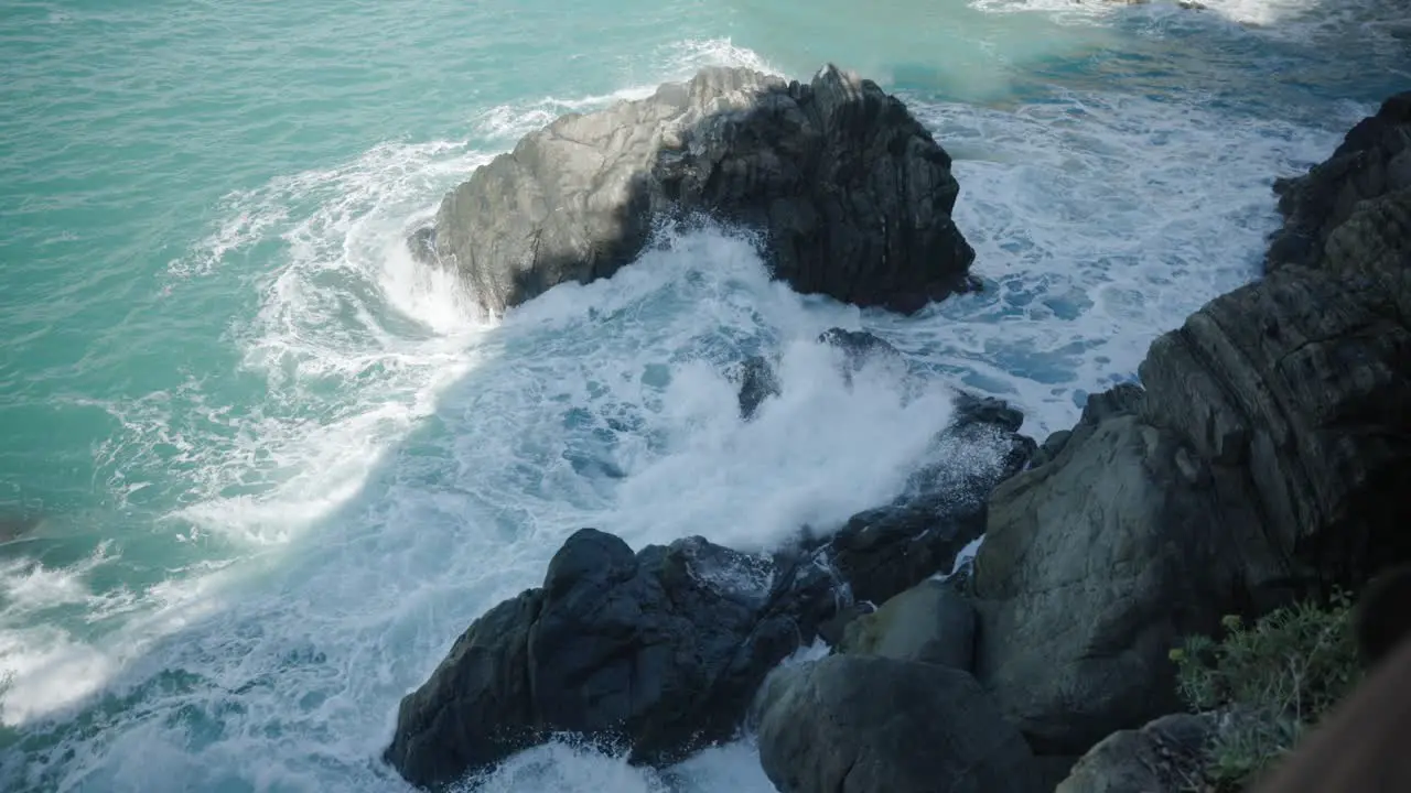 White waves splashing on the rocks of Italy Slowmo