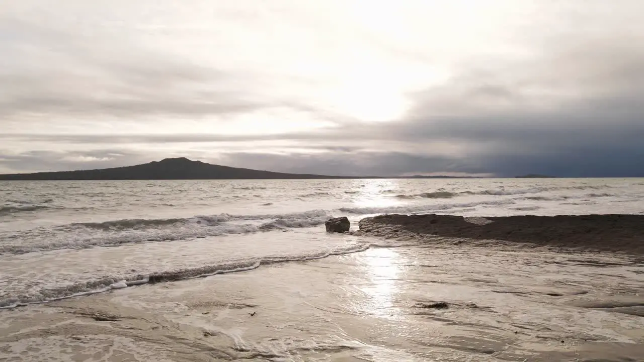 Forward dolly shot from the sandy beach of