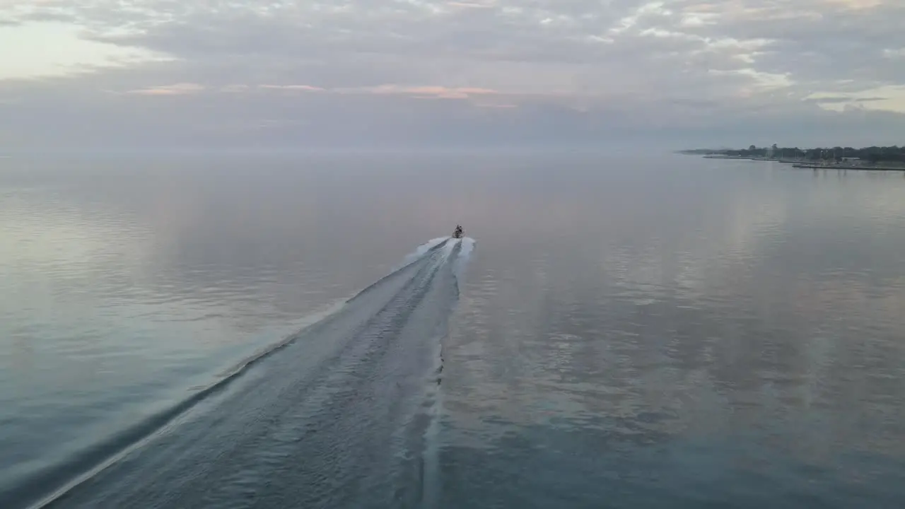 Big Waves Behind Speeding Watercraft Cruising On Tranquil Ocean