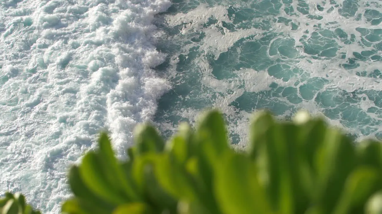 Slow motion view of tropical ocean waves crashing swirling and foaming