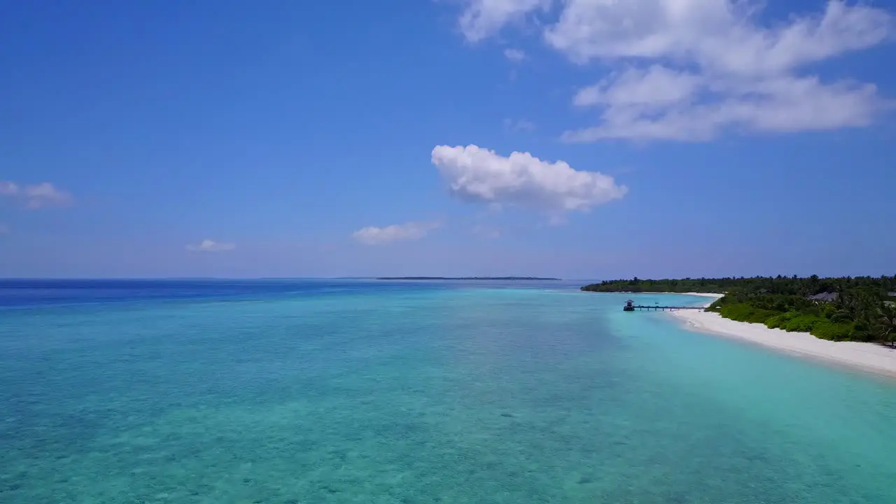 Tropical lagoon scene aerial push forward no people or boats untouched sea 4k