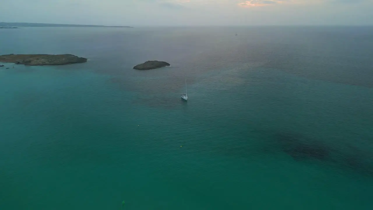 Lonely alone sailboat in front of island