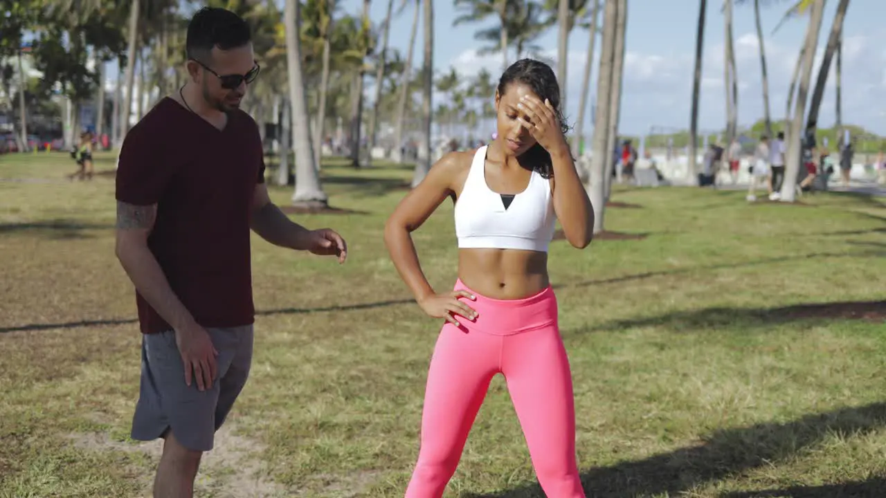 Man helping girl with squat technique