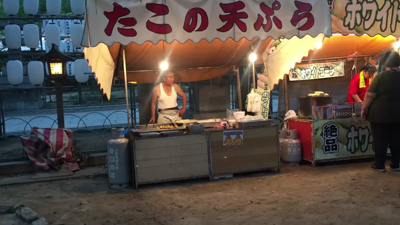 Street vendor cooking on the street in Osaka Japan at night