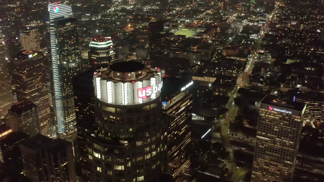 Scenic Los Angeles Cityscape Skyline with Huge Skyscrapers glowing City lights at Night Aerial Wide Establishing Shot Circa 2019