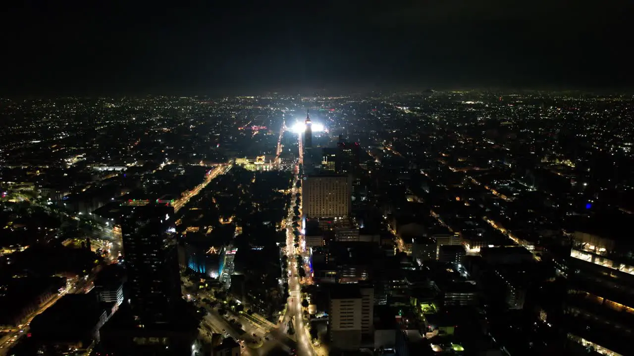 drone shot of diverse color fireworks demonstration at mexico city zocalo and torre latinoamericana at independence day