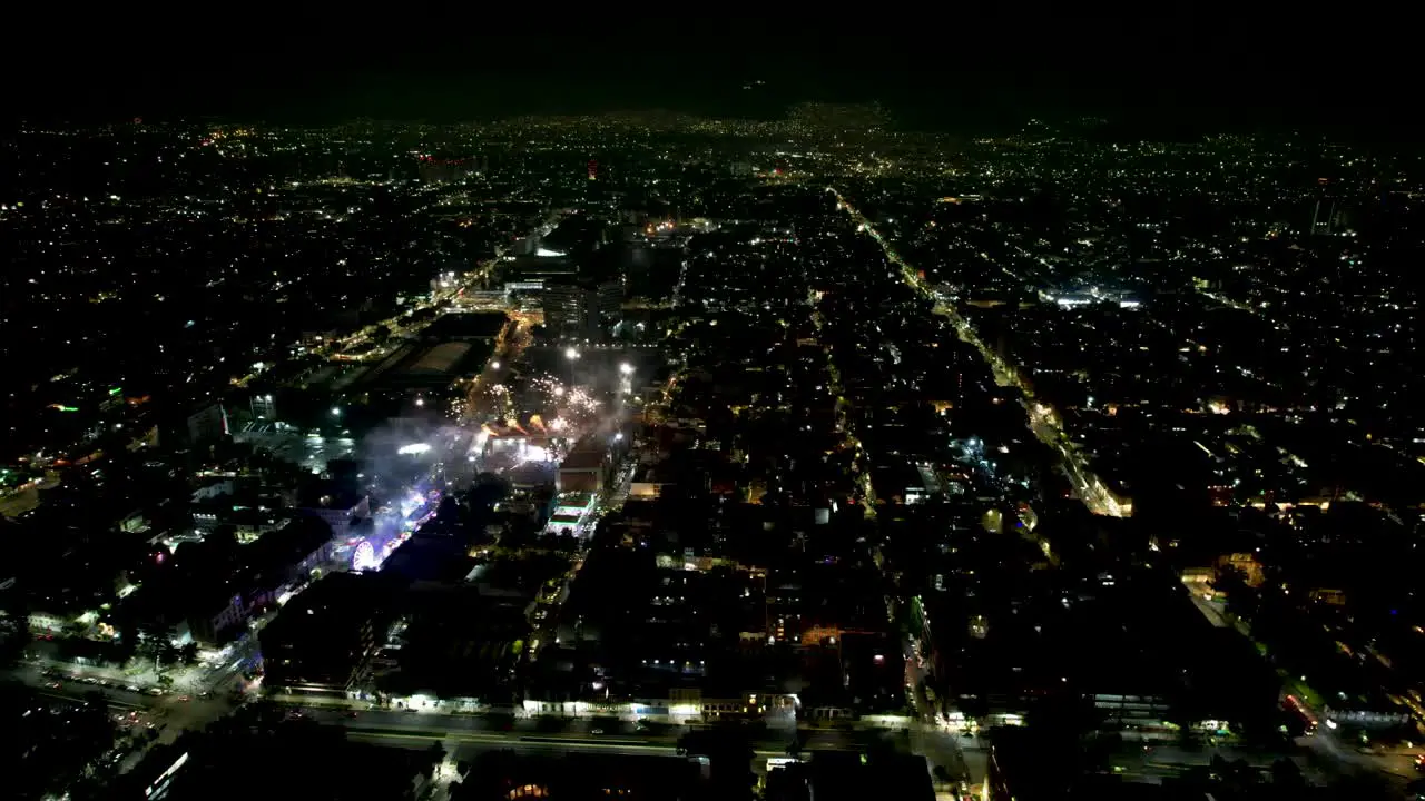 drone shot of diverse color fireworks demonstration at mexico city during independence day at night