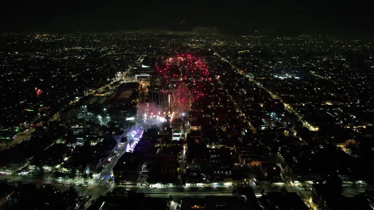 drone shot of diverse color fireworks demonstration at mexico city alcaldia cuauhtemoc at independence day at night